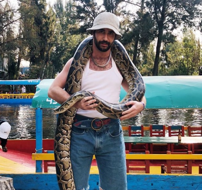 Jordan Firstman at a national park with a snake