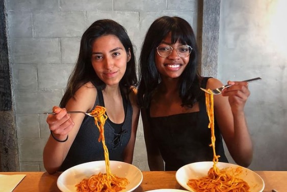 Kelly with her friend eating at a restaurant