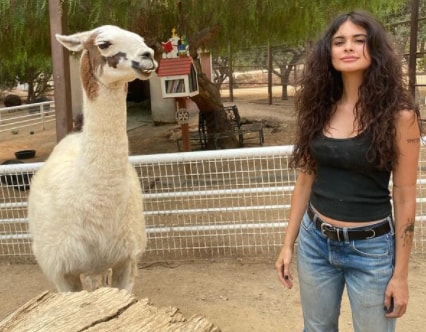 Sophia Esperanza posing with llama