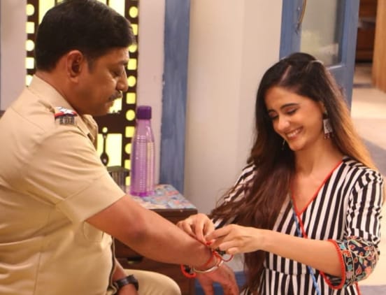 Ayesha Singh stitches safety band on the arm of her dad