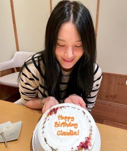 Claudia Kim cutting her birthday cake