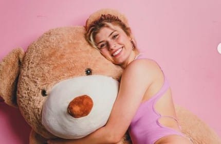 Faith Ordway hugs her teddy bear