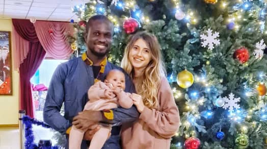 Ike Amadi with his wife and young child