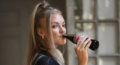 Alexis Gomez drinks coca cola