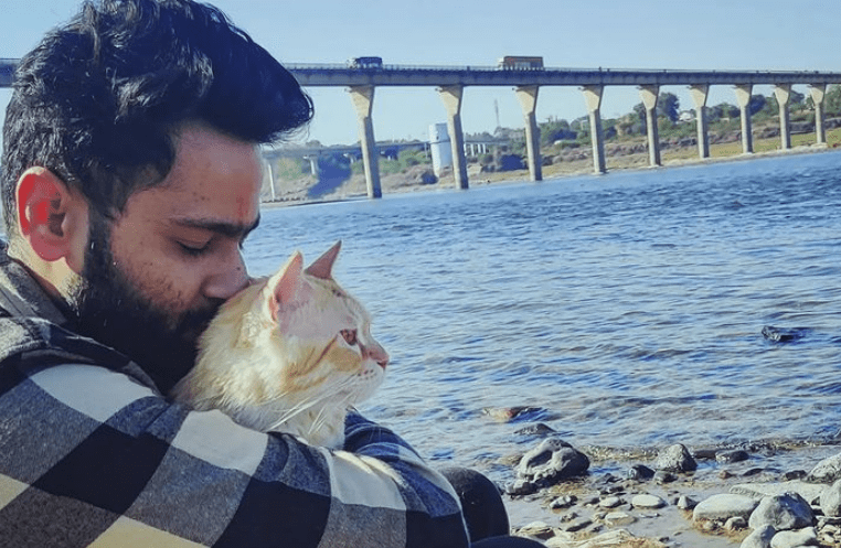 DJ Tan with his pet cat spending time at a scenic location