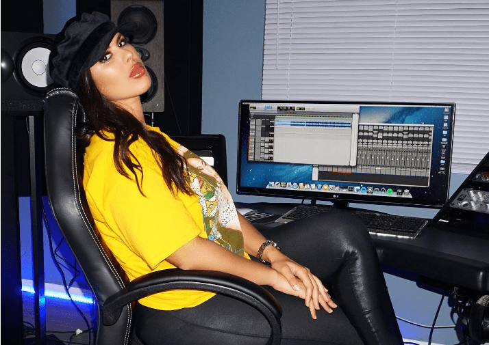DJ Yasmina sitting at her music room