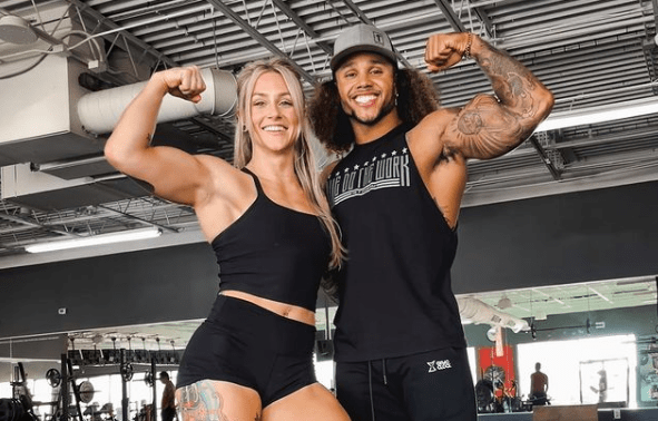 Josie Hamming with Stacey Ervin Jr. showing their biceps