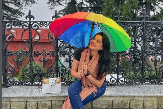 Sarah Hussain doing photoshoots with a colorful umbrella