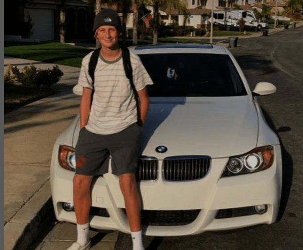 Mason Rizzo taking pictures in front of his car