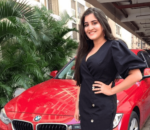Navika Kotia showcasing her luxurious red car