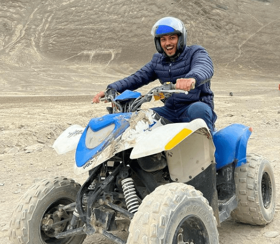 Shlok Srivastava rides on a 4-wheeler vehicle