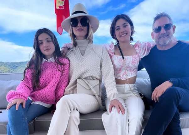 Elena Cardone with her husband and daughters spend a vacation at a scenic place