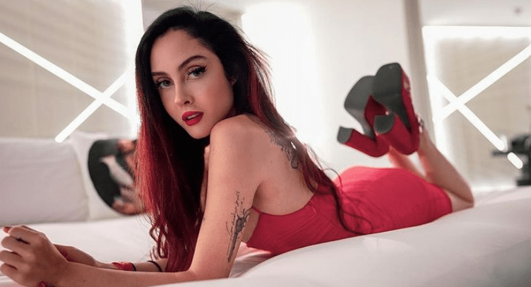 Maren Altman doing a photoshoot in her bedroom in red attire