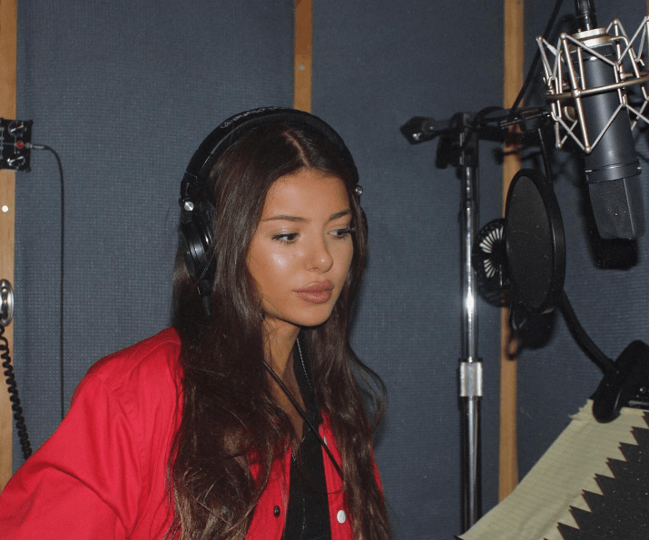 Noriella is recording music at a music studio