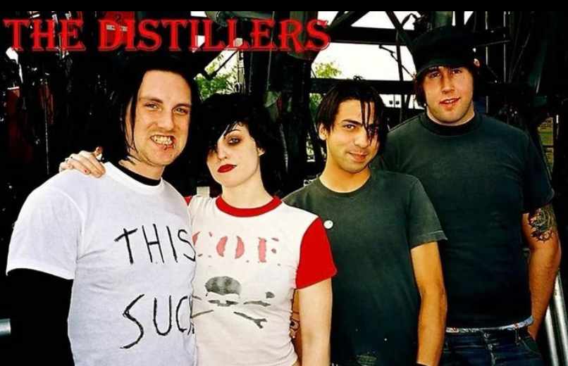 Brody Dalle with the members of The Distillers